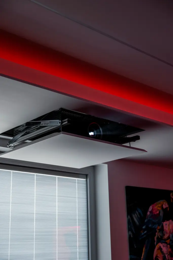 Proiettore incassato a scomparsa nel controsoffitto con illuminazione LED rossa, installazione personalizzata da Ebanisteria Stasi